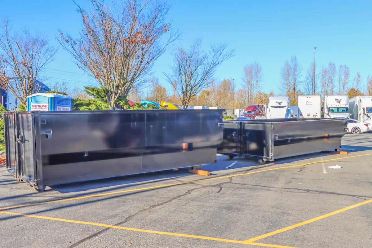 Professional dumpster rental service with roll-off container on residential driveway in South Barrington